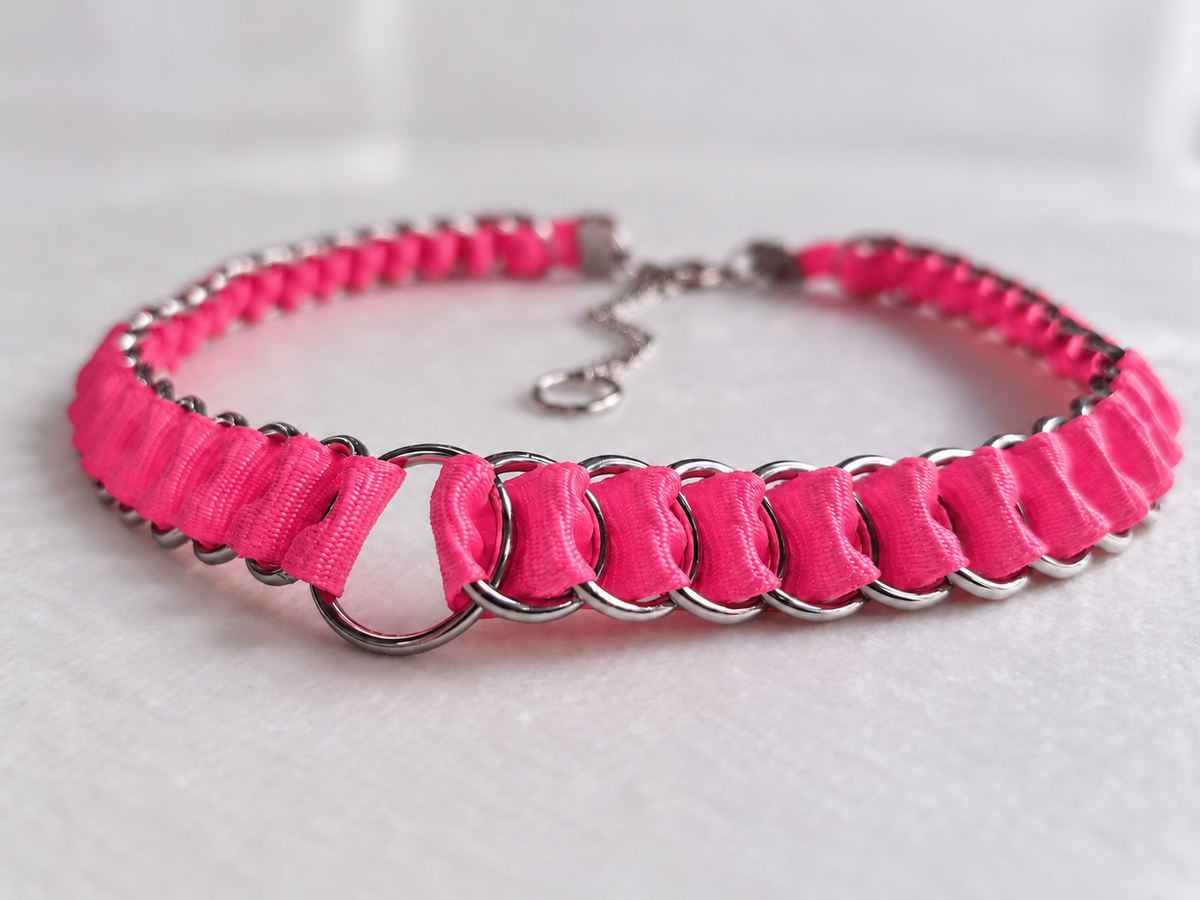 Low-angle front view of the LOOM Barbie Pink fabric ribbon chainmail choker, showing ribbon texture and the central stainless steel O-ring.