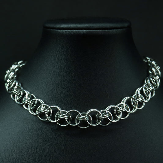 Front view of a handmade stainless steel chainmail choker with interlinked rings and a polished, structured weave.