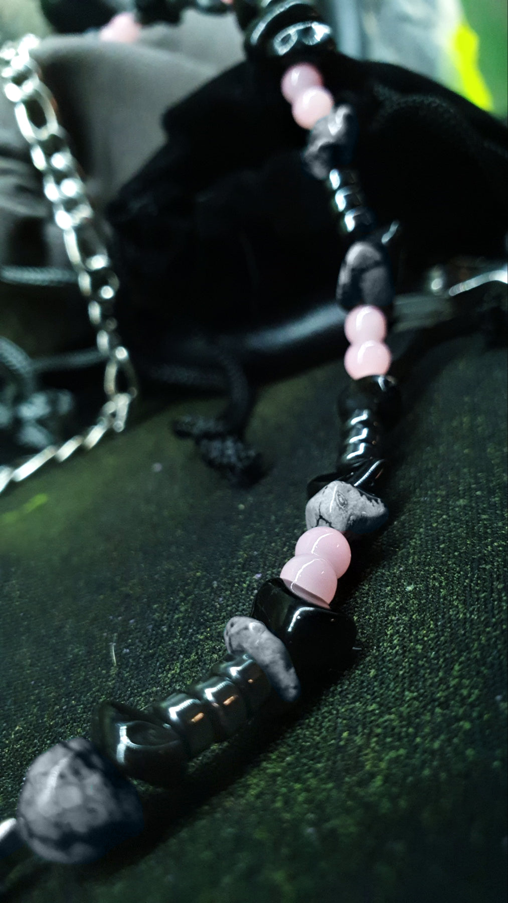 RAVEBOUND necklace featuring black stones and silver chain