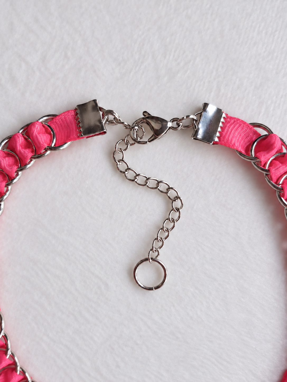 LOOM Barbie Pink choker fastening detail showing stainless steel ribbon clamps, lobster clasp, extension chain and end ring.