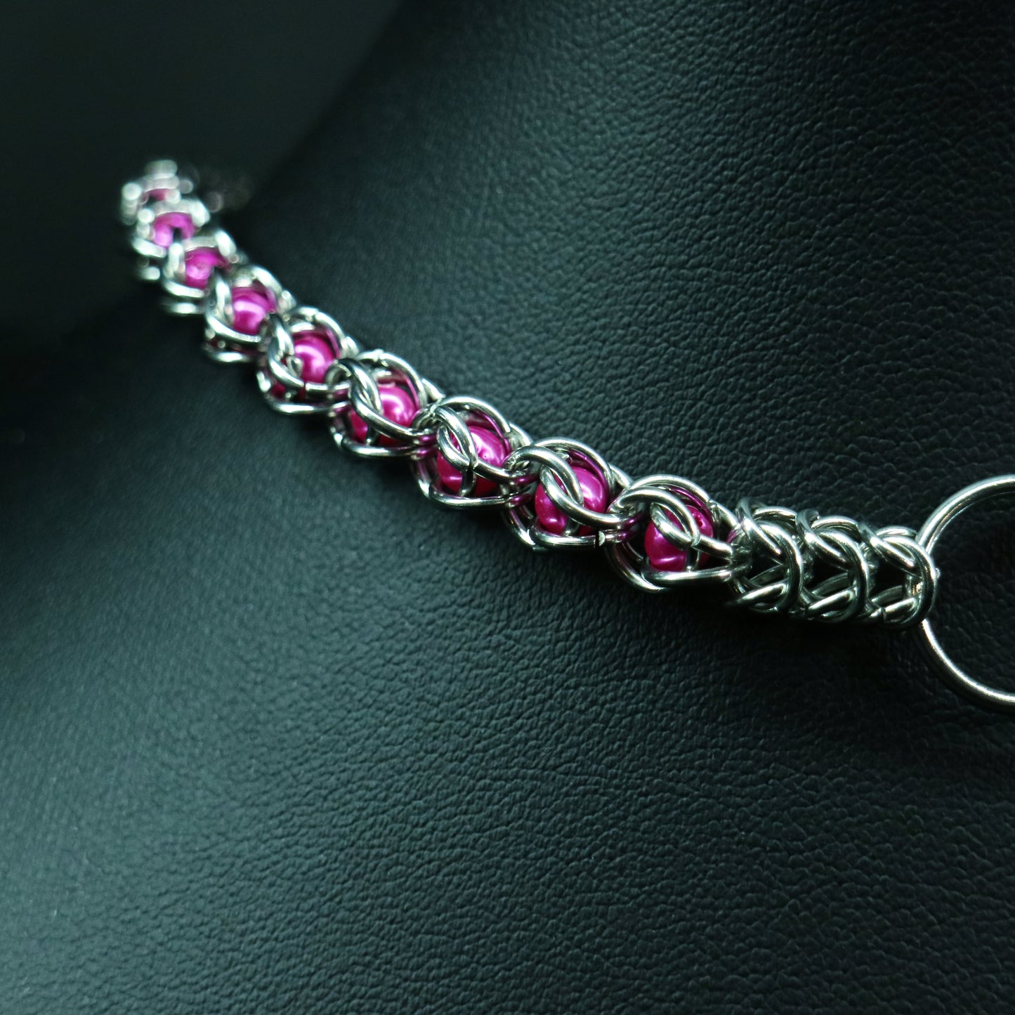 Stainless-steel chainmail choker in pink  glass pearl accents.