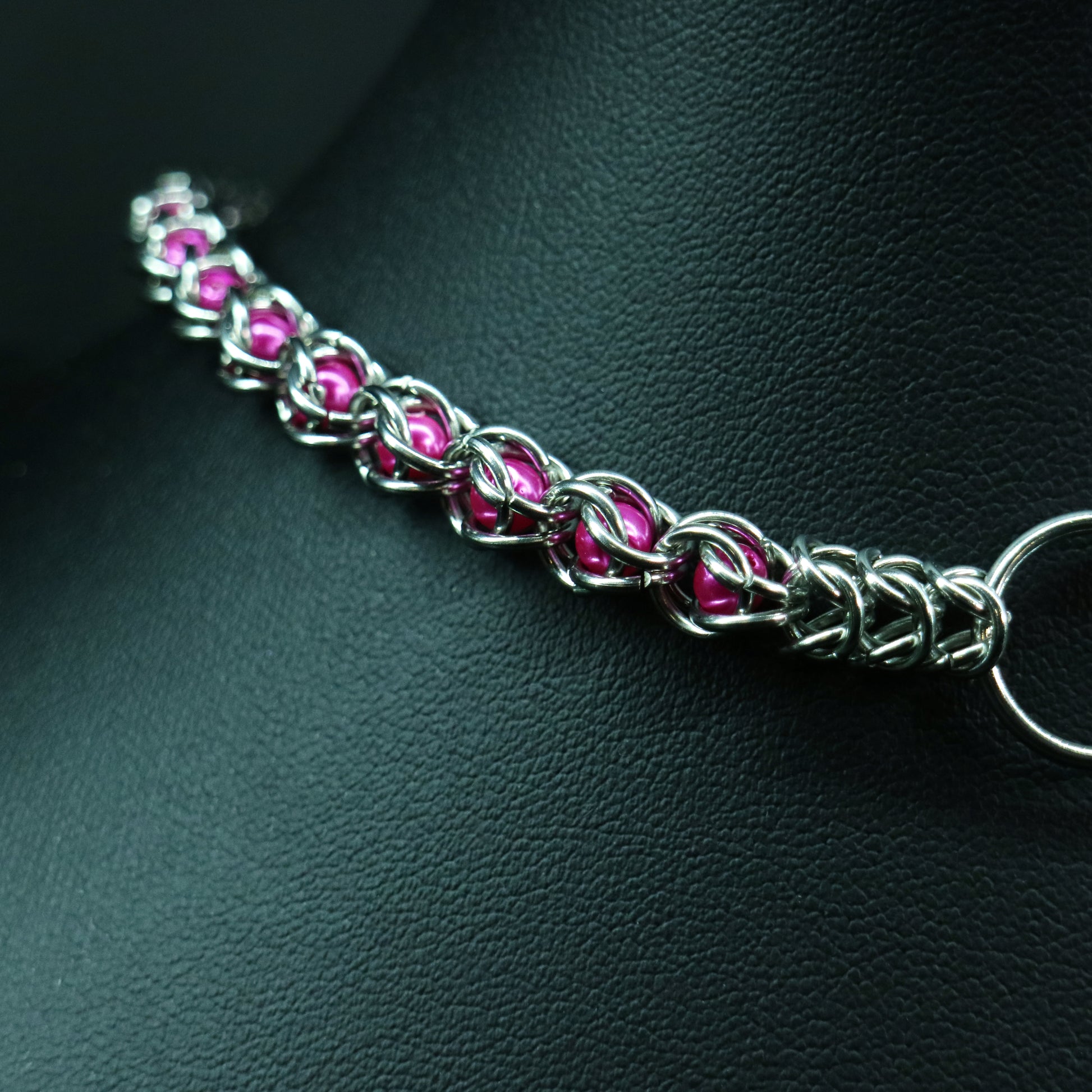 Stainless-steel chainmail choker in pink  glass pearl accents.