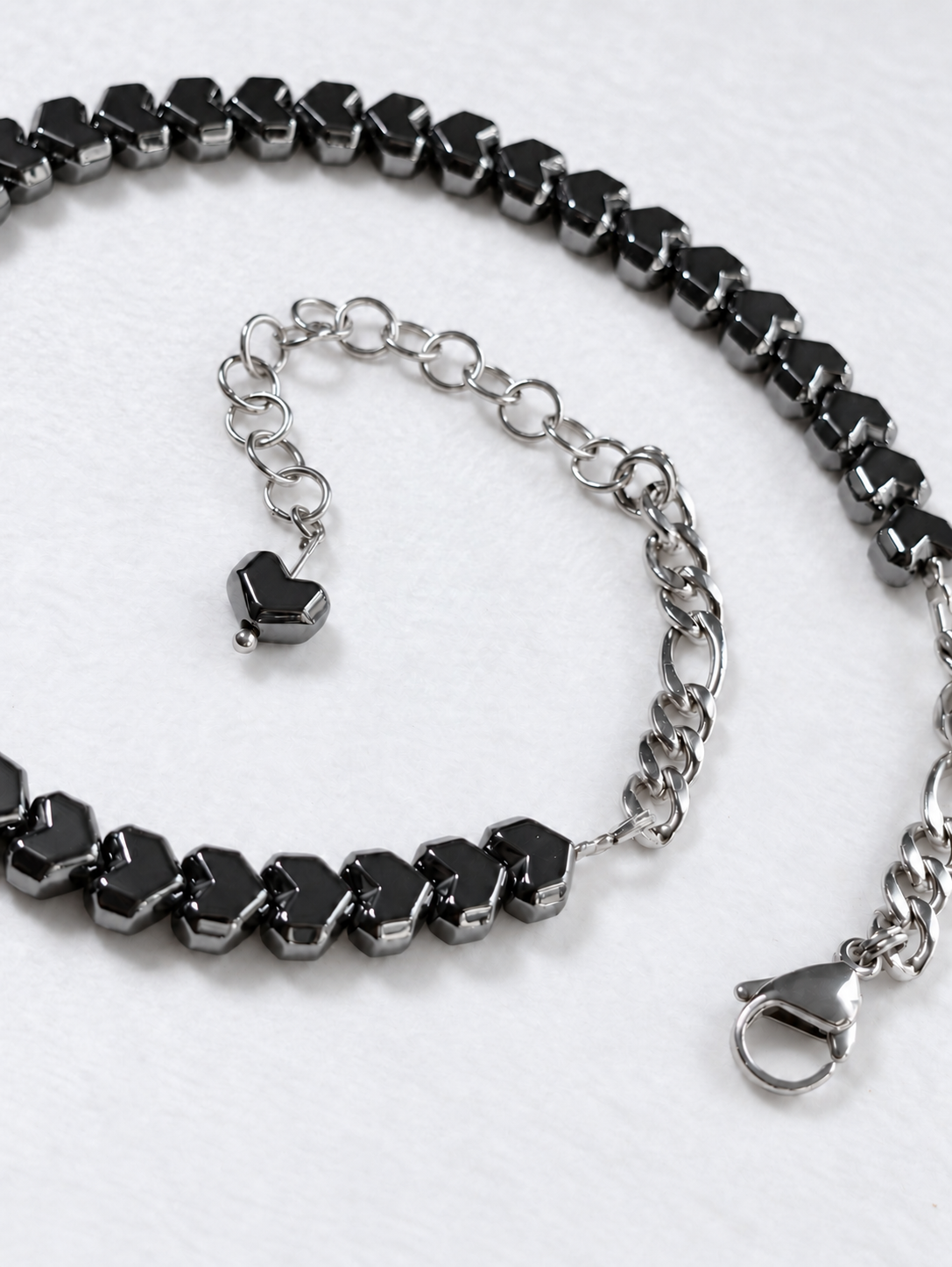 HARDLINE gunmetal hematite heart choker showing stainless steel rear chain, lobster clasp and extension with a matching heart bead.