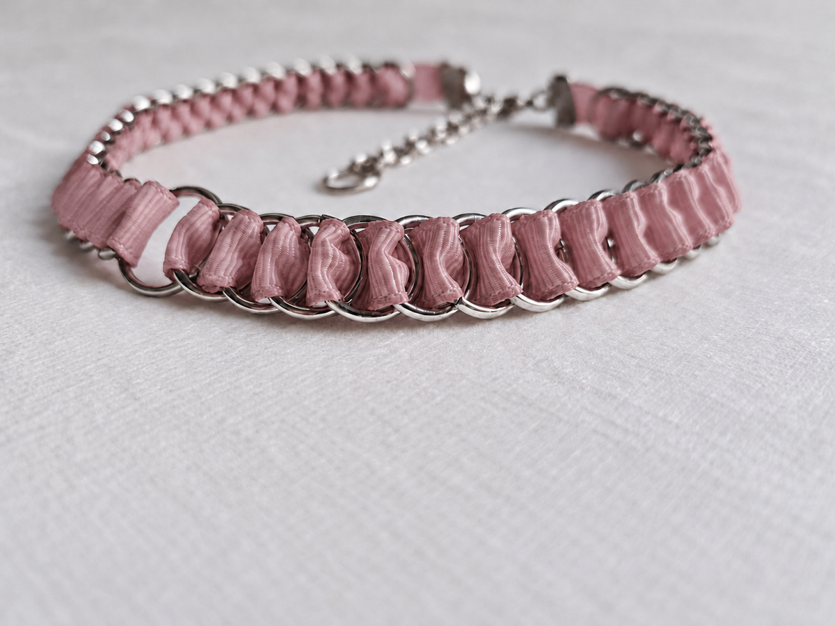 Detail of folded dusty pink fabric ribbon and interlinked stainless steel rings on the LOOM choker.