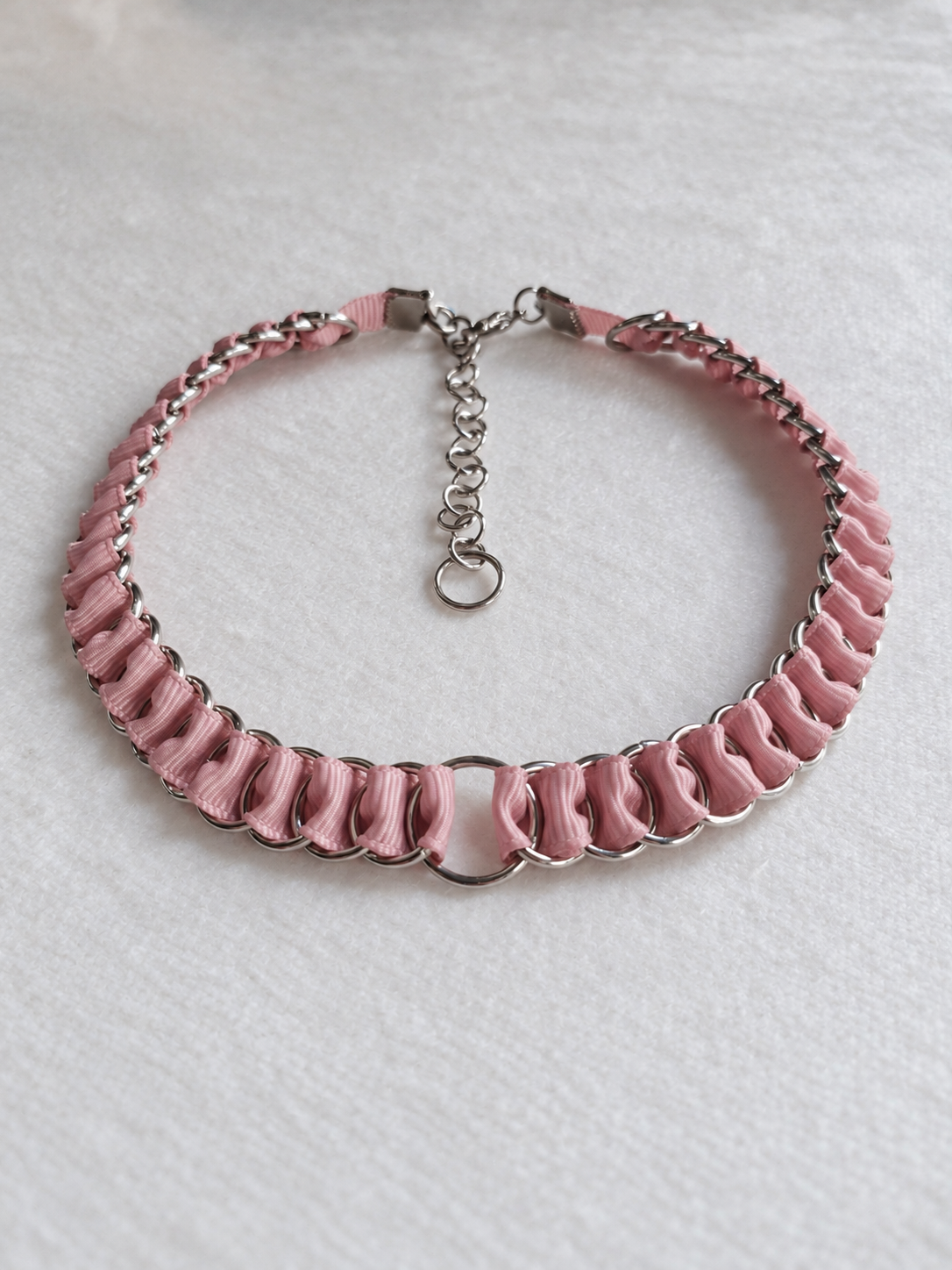 Full overhead view of the LOOM dusty pink ribbon chainmail choker with central O-ring and adjustable stainless steel closure.