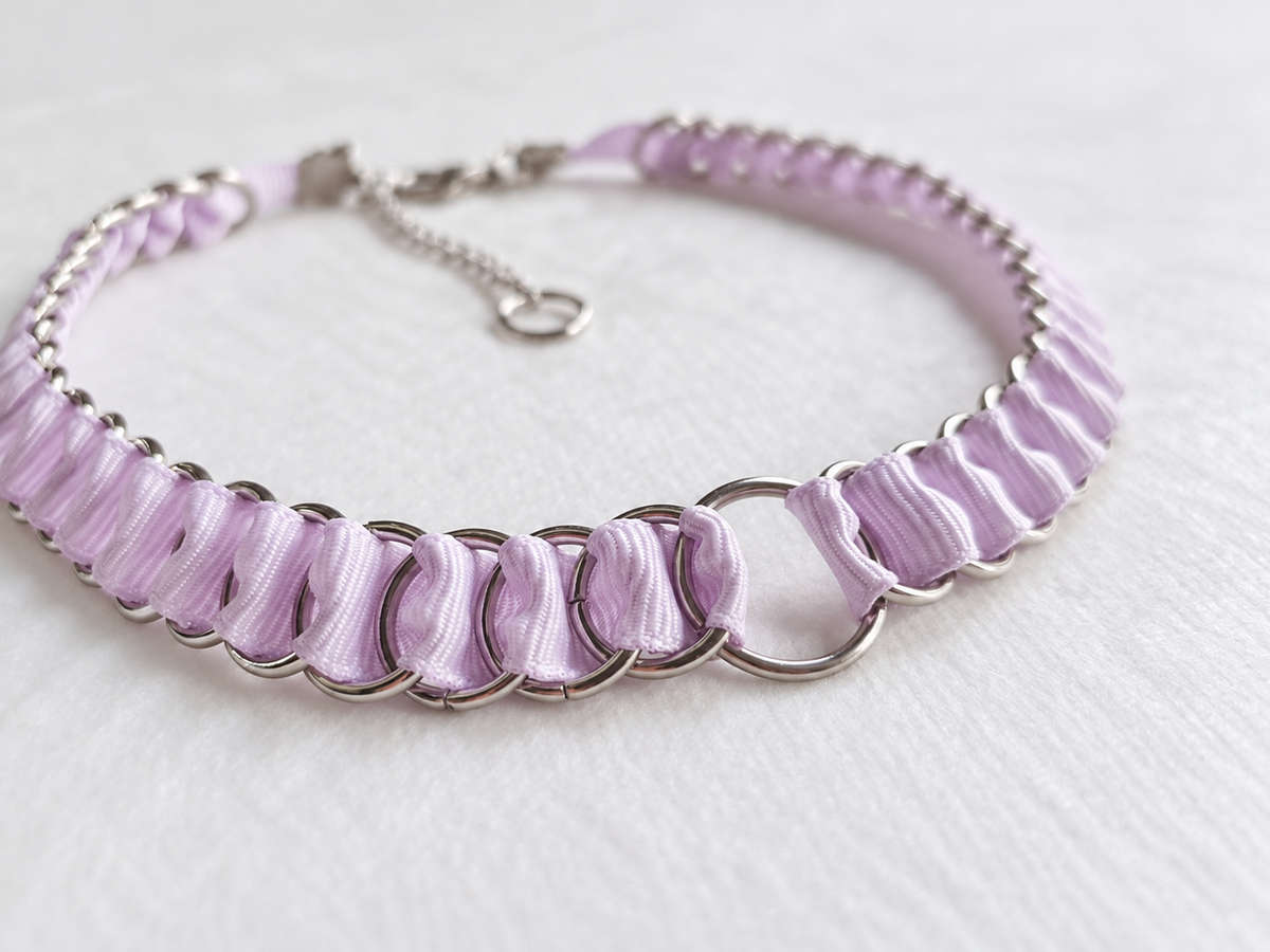 Detail of folded lilac fabric ribbon and interlinked stainless steel rings on the LOOM choker.