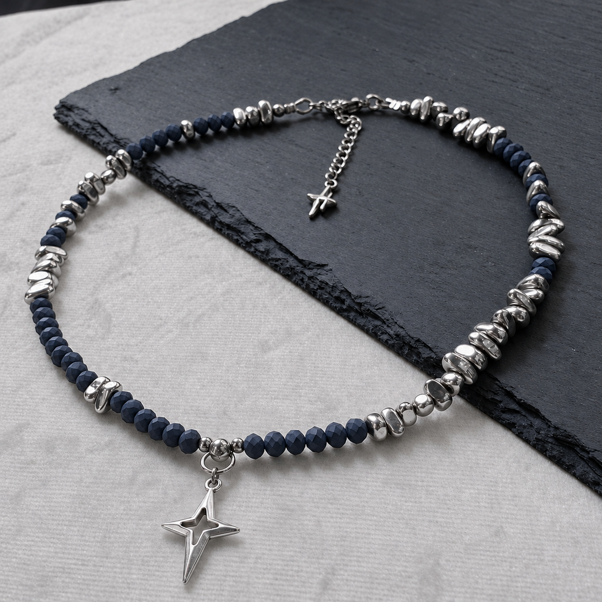 Alternate full view of NIGHTMARK's midnight blue crystal and silver hematite necklace, central North Star pendant and star-tipped extension.