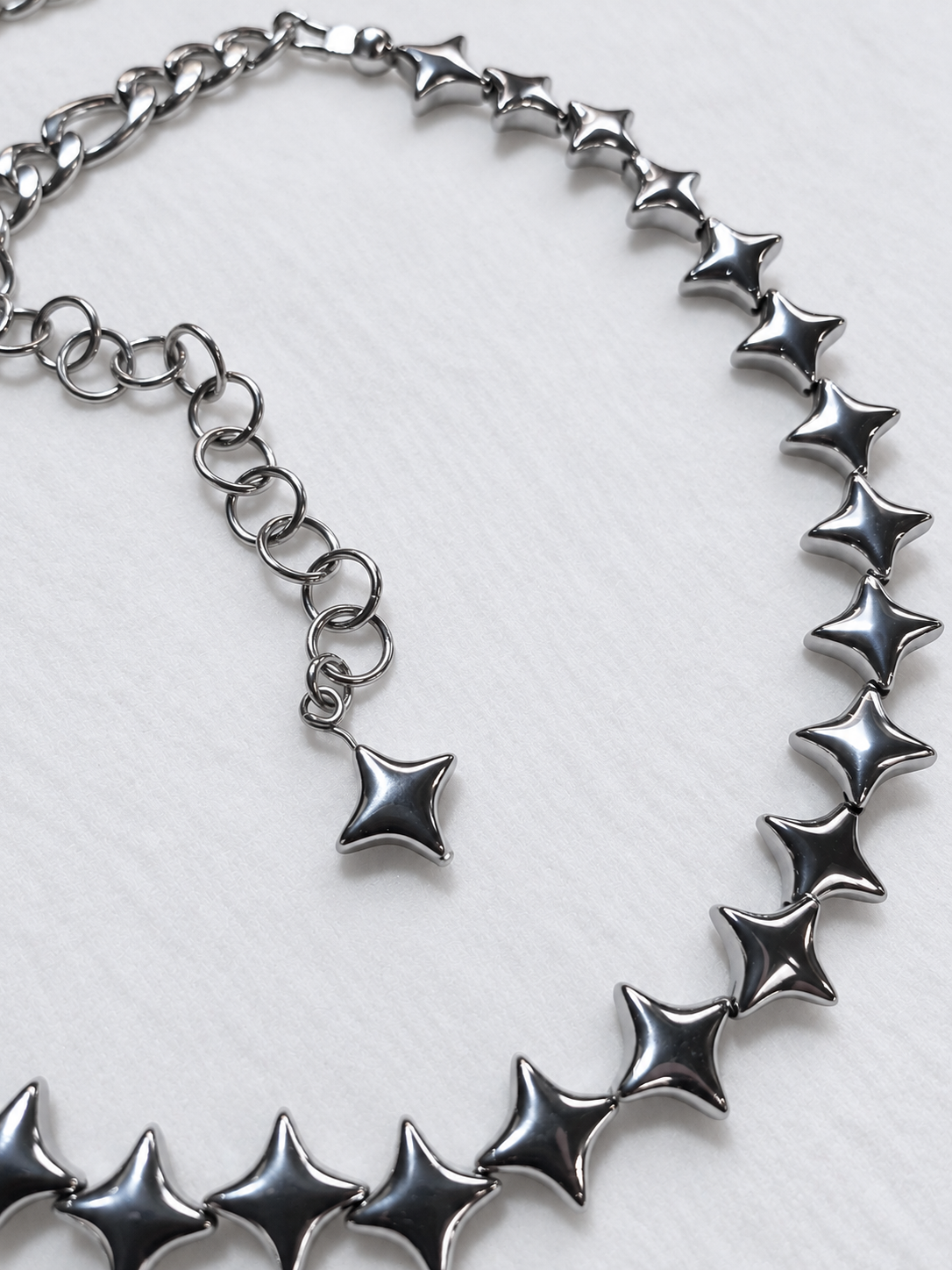 NORTHLINE Silver choker detail showing the stainless steel extension chain, matching hematite star tip and polished North Star beads.
