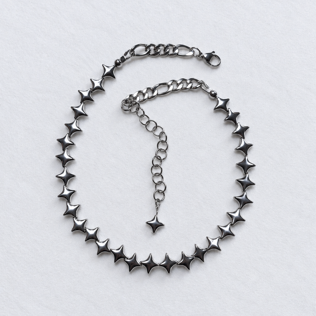 Overhead view of the complete NORTHLINE Silver North Star hematite choker with stainless steel rear chains and adjustable extension.