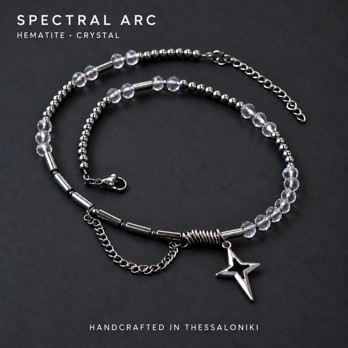 SPECTRAL ARC crystal and silver hematite necklace with a silver-plated North Star pendant, shown on charcoal with the text Hematite · Crystal and Handcrafted in Thessaloniki.