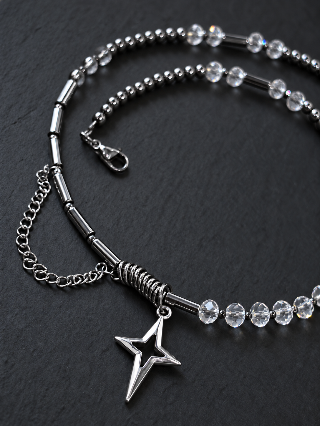 SPECTRAL ARC front detail showing the North Star pendant, ring-wrapped tube section, silver hematite tubes and draped stainless steel chain.