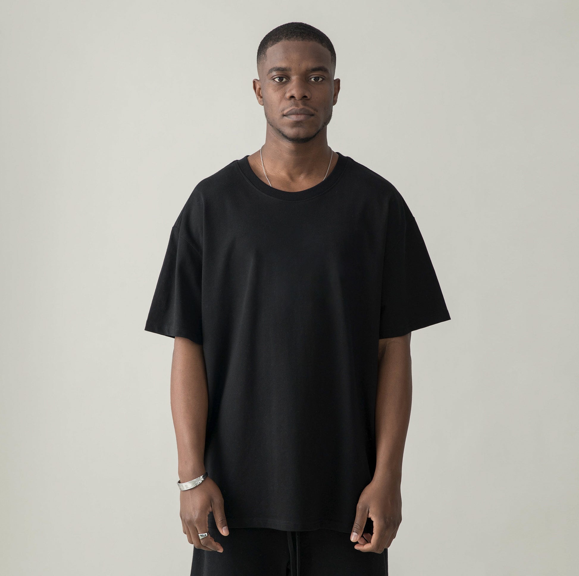 Model in ACID FANTASY (BACK PRINT) - Unisex Oversized T-shirt - black - front view