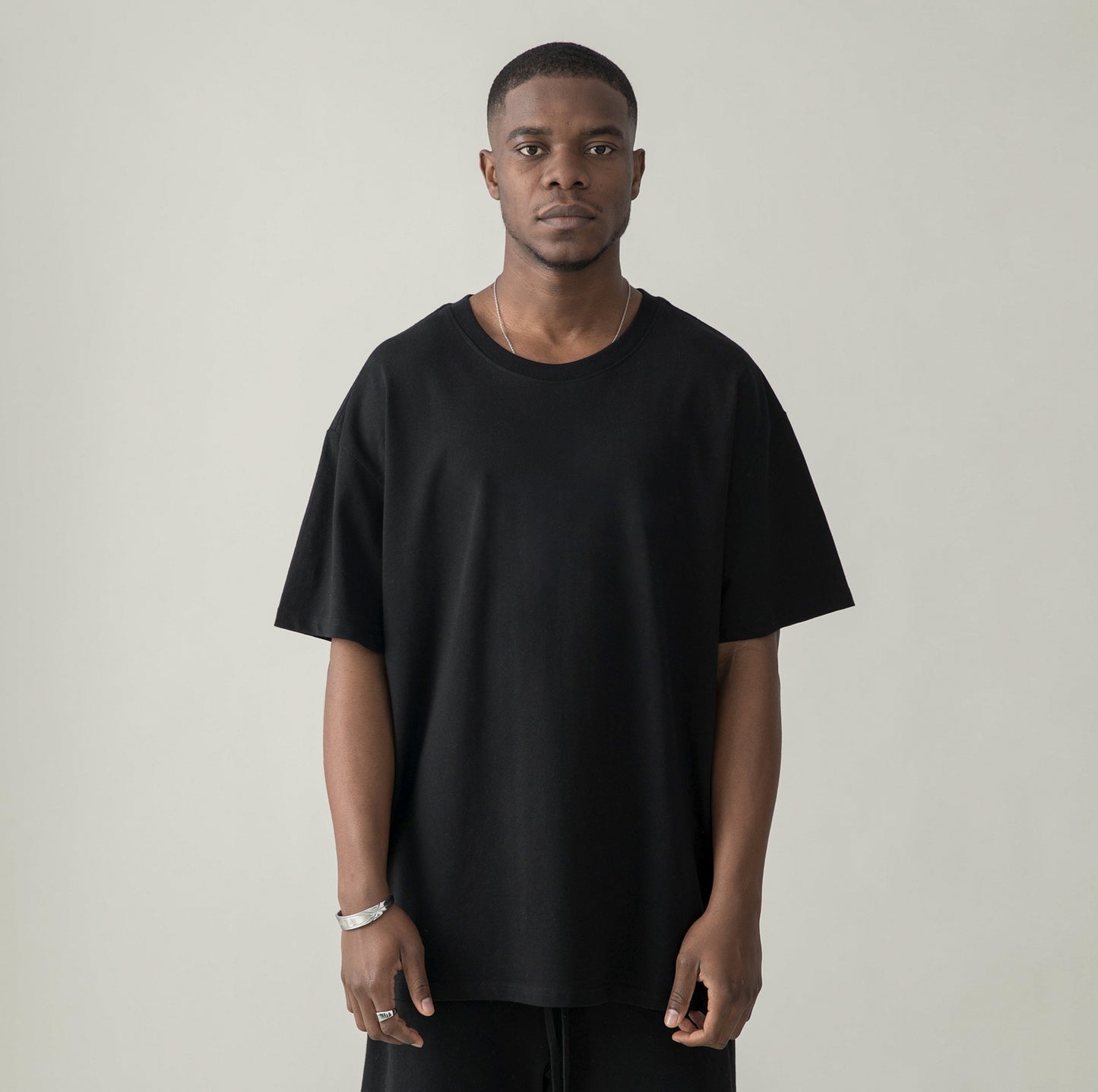 Model in DON'T PANIC (BACK PRINT) - Unisex Oversized T-shirt - black